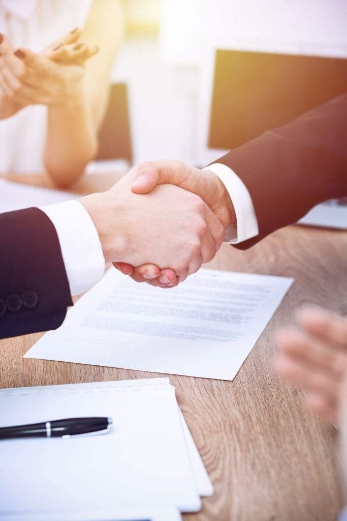 Business people shaking hands at meeting or negotiation in the office. Handshake concept. Partners are satisfied because signing contract.